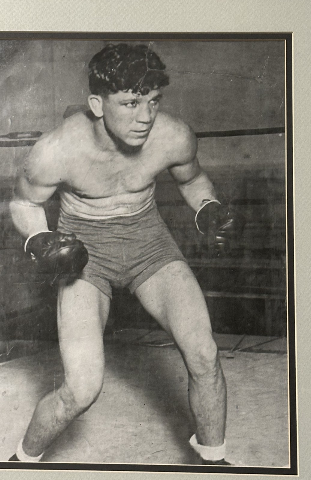Cecil Payne in fighting stance in the ring — a young featherweight in trunks and gloves, compact and powerful, looking off to his right